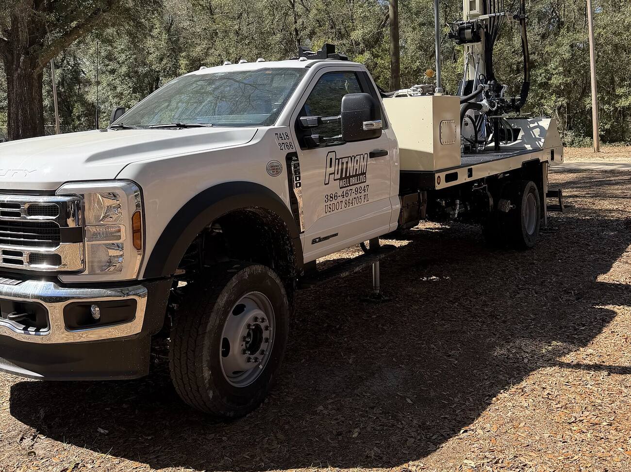 Putnam Well Drilling's drill rig truck set up on a job site
